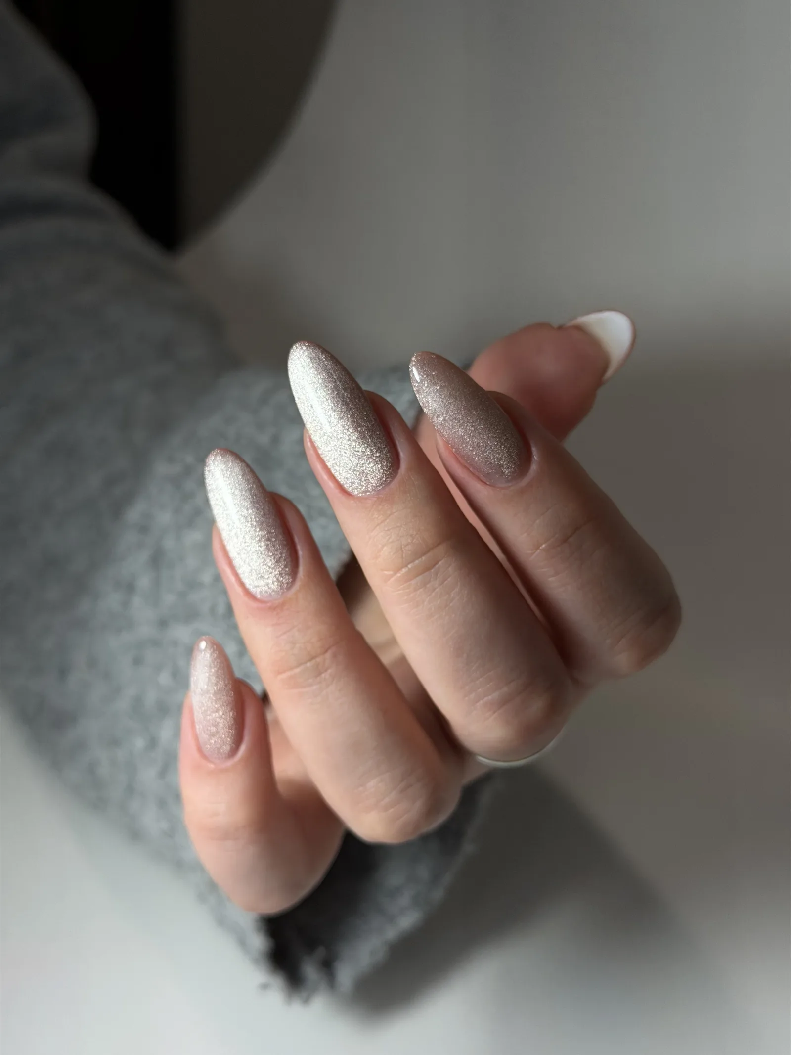 Pearl white cat eye manicure on long almond nails