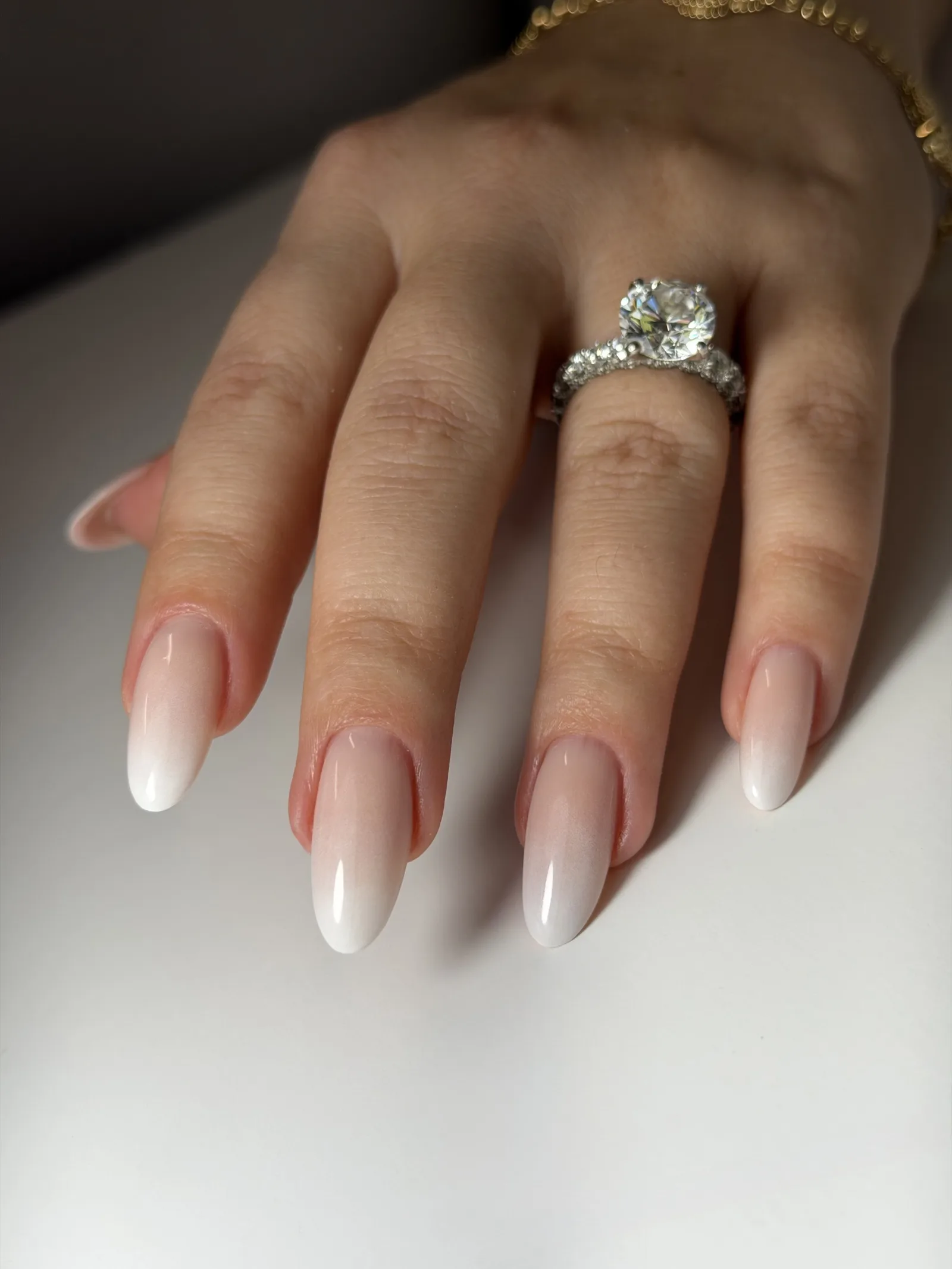 Nude-to-white ombré on long almond nails