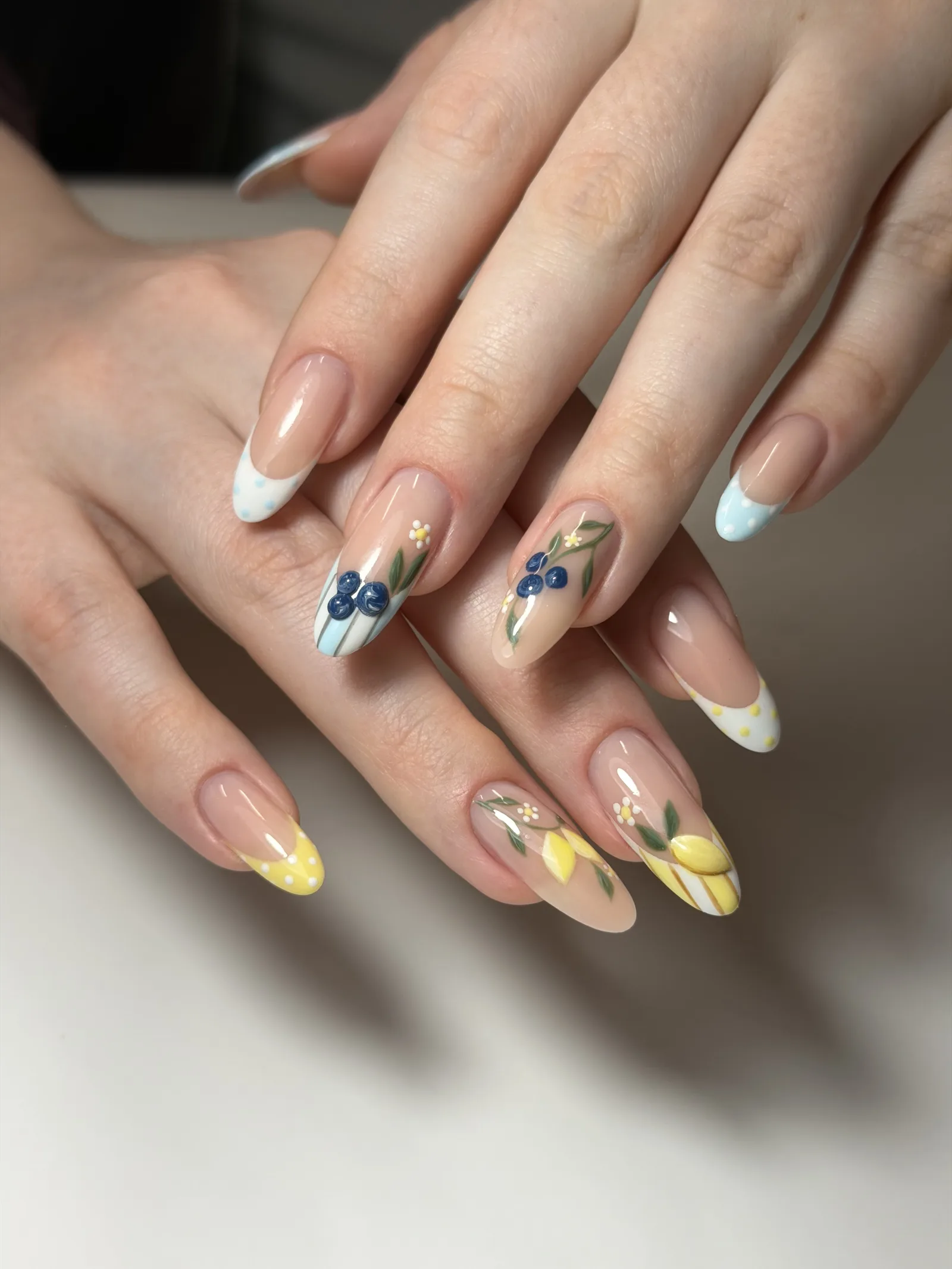 Hand-painted blueberries and lemons on nude almond nails